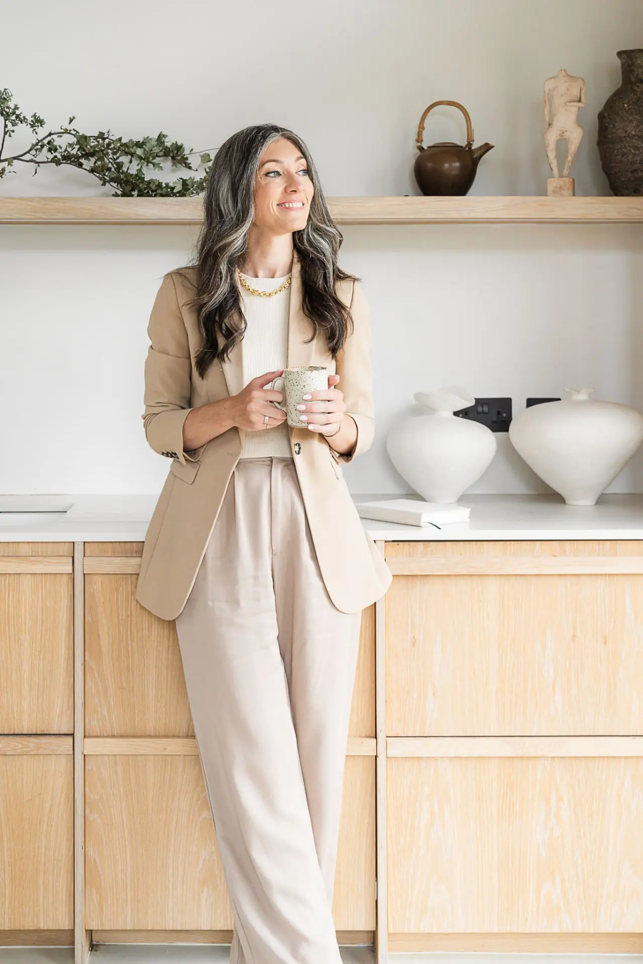 Portrait of Dr Lafina Diamandis, GP and Lifestyle Medicine Physician, smiling in a bright kitchen
